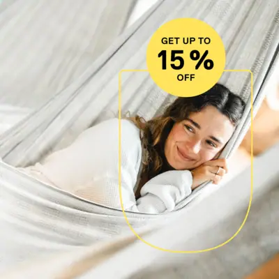 Low Season Offer A smiling woman is lying in a hammock.