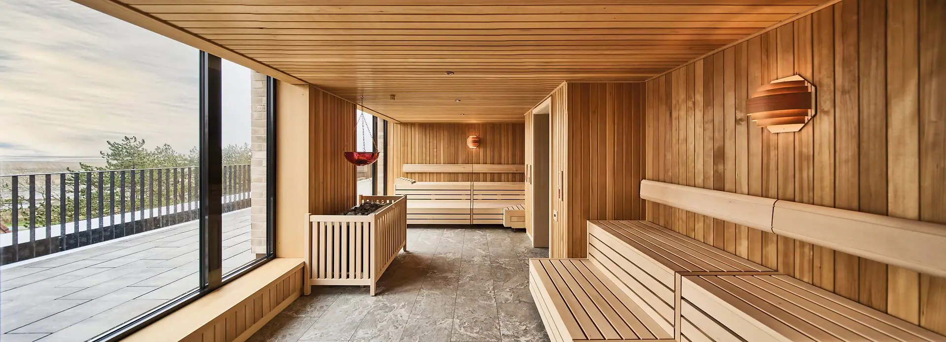 Sauna A room with wooden walls and a bench.
