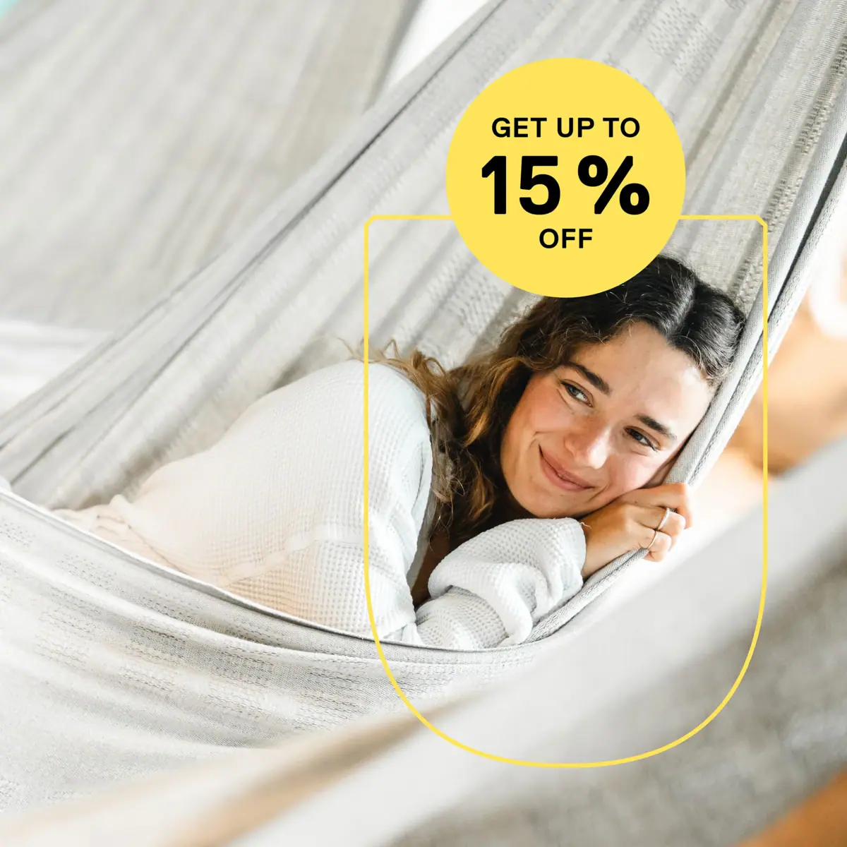 Low Season Offer A woman is lying in a hammock, smiling.